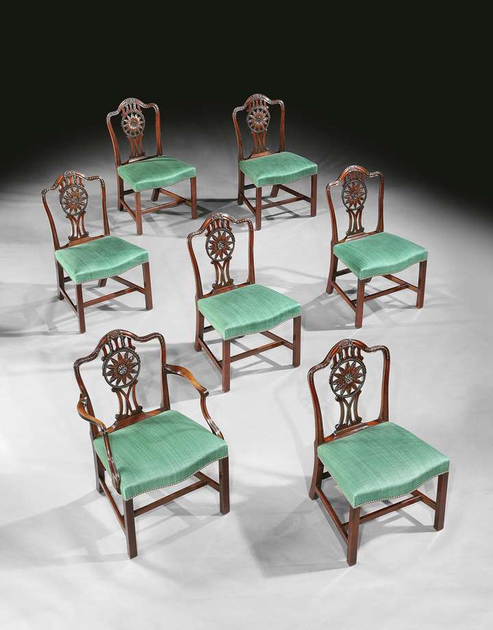 A SET OF FOURTEEN GEORGE III MAHOGANY DINING CHAIRS
